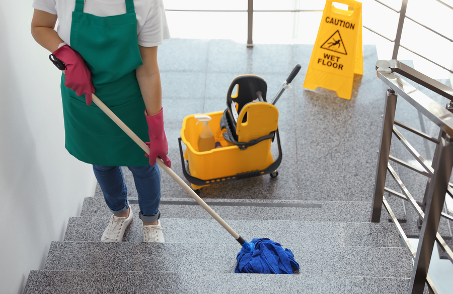 girl cleaning the tile stairs using a mop