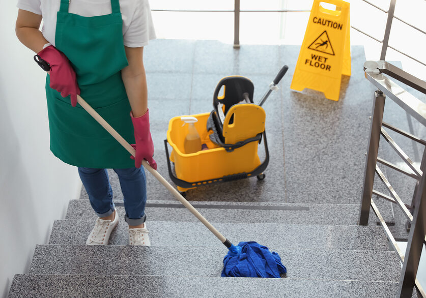girl cleaning the tile stairs using a mop