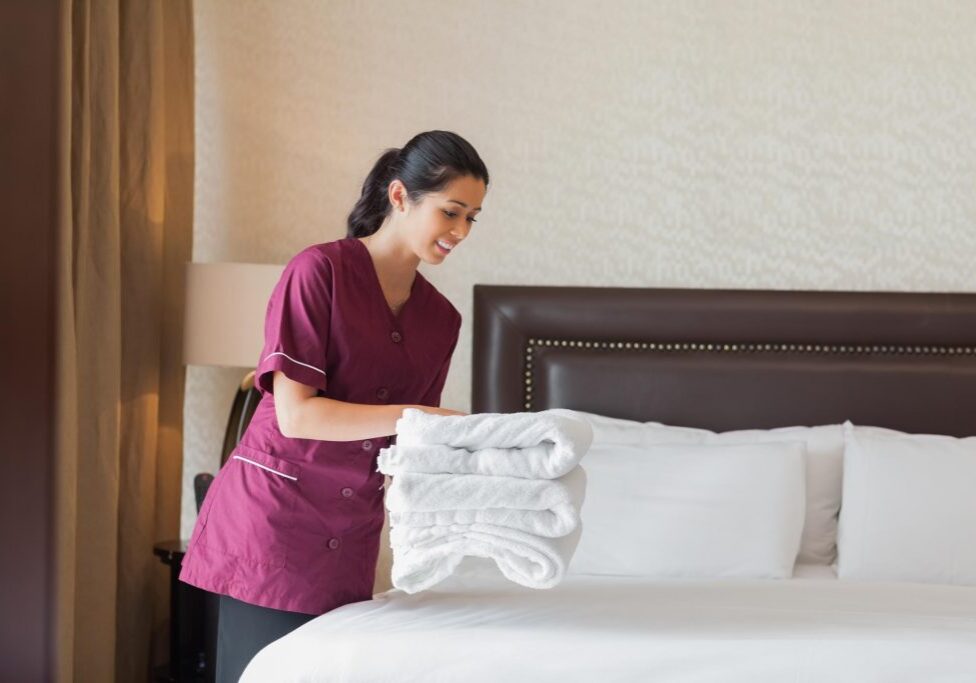 maintenance girl folding the white towels